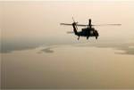 An Air Force helicopter flys over Lake Pontchatrain to New Orleans