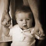 Baby Holding Mom And Dad Hands by Tanya Hovey