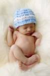 Baby In Blue Knit Hat by Tanya Hovey