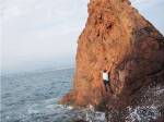 Deep Water Solo on a small rock at Point de l'Aiguille