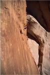 Low angle view of a man climbing a mountain, Utah, USA