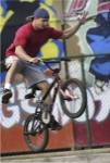 Low angle view of a teenage boy performing a stunt on a bicycle