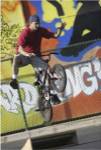 Low angle view of a teenage boy performing a stunt on a bicycle
