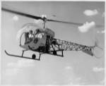 Low angle view of two people sitting in a helicopter, Bell 47G-2
