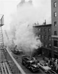 New York City, Fire on East 47th Street, with fire engines shooting water on burning building