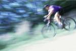 Side profile of a young man riding a bicycle