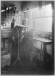 Thomas Alva Edison, full-length portrait, standing, facing right, listening to a new record