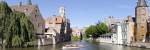 Tourboat in a canal, Bruges, West Flanders, Belgium by Panoramic Images