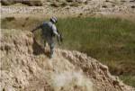 U.S. Army Specialist climbs down to the bottom of a canal near Tal Jawal village, Iraq