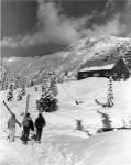 USA, Washington state, three people carrying their skis