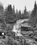 Waterfall Over Rock With Wildflowers by Gordon Semmens