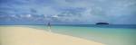 Woman in distance on sandbar, Aitutaki, Cook Islands by Panoramic Images