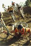 Young man falling off his bicycle in a race